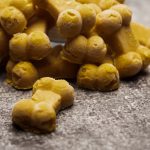 Frozen Pumpkin Peanut Butter Dog Treats stacked on a gray background